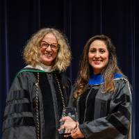 faculty posing with award